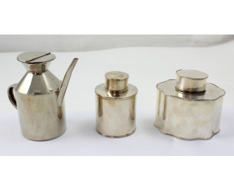A white metal lobed tea caddy (af), a further smaller example, and a stainless steel jug (3).
