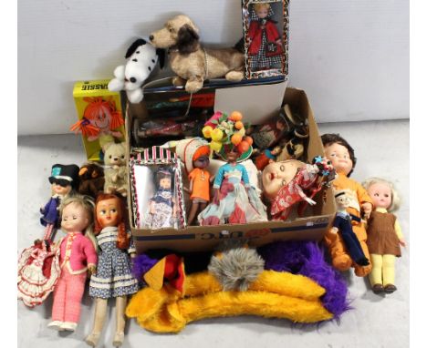 A box of vintage dolls, mainly costume dolls, a c1960s baby doll, cuddly toys and a 'Sassie' talking doll and a boxed Emu arm