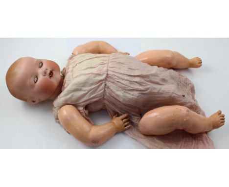 An Armand Marseille bisque head doll marked Germany 351/10.k, with silk robe, opening and closing eyes, and open mouth with t