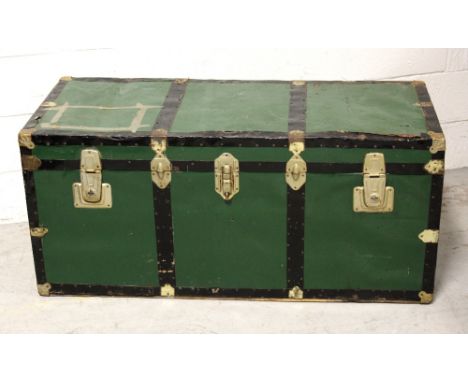 An early 20th century large green painted metal travelling trunk with black metal and brass trim, 116 x 50cm.