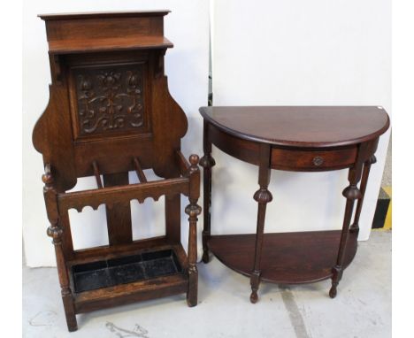 A late 19th century oak stick stand, single shelf over carved panel and three-compartment stick holder with drip tray, height