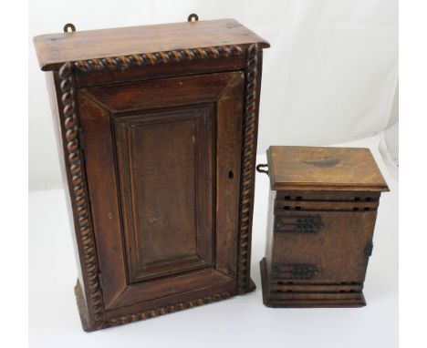 A small stained pine wall-mounted cabinet with single panel door opening to reveal a single shelf and plank back, height 42cm