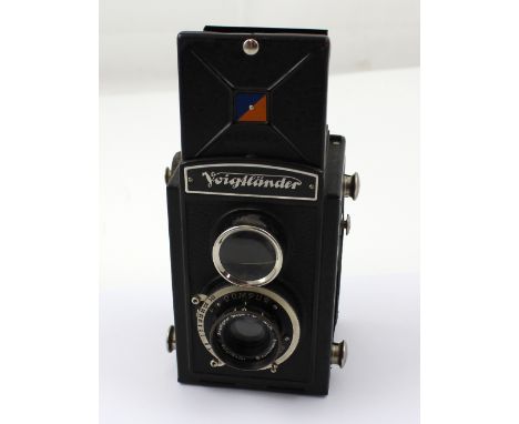 A Voigtländer Brilliant twin-lens reflex camera with Compur F7.5cm lens, presented in original blue lined leather carry case,