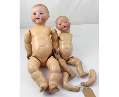 Two early 20th century Armand Marseille bisque head baby dolls with composite bodies; one with fixed blue eyes, open mouth an