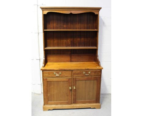 A small vintage mahogany and pine two drawer over two door dresser with plate rack, height 193cm.