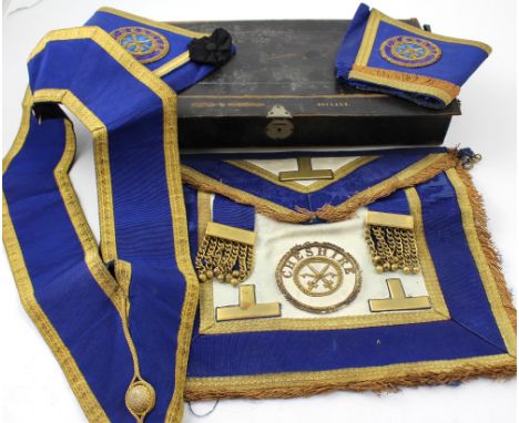 A small collection of Masonic regalia to include apron, sash, epaulettes and rosettes in black leather case, width 47cm.