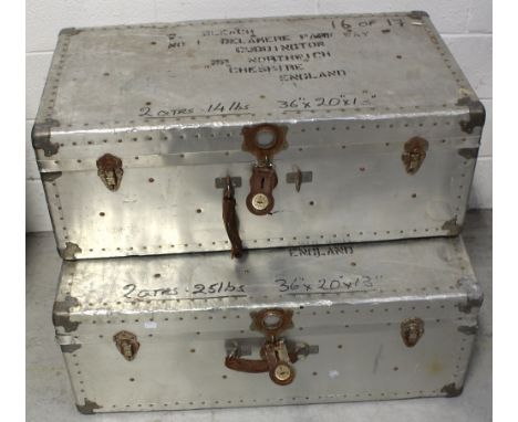 Two vintage metal travelling trunks with metal and stud trim, and leather carrying handles, 90 x 35cm (2).