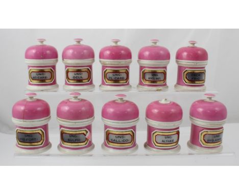Fifteen French pink finish ceramic apothecary jars with impressed marks 'Y G &amp; Co' to the base, some with original cerami