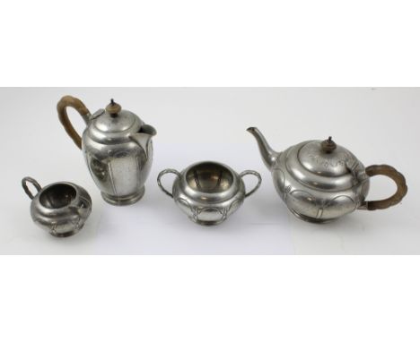 A period pewter four-piece tea service comprising teapot, milk jug, sugar bowl and hot water jug, the teapot and hot water ju