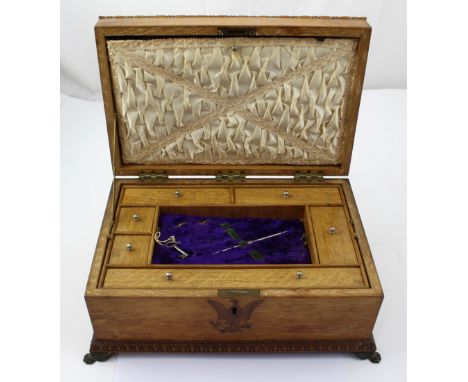 An early 20th century Canadian oak workbox the fitted interior with hidden correspondence compartment to the lid, a removable