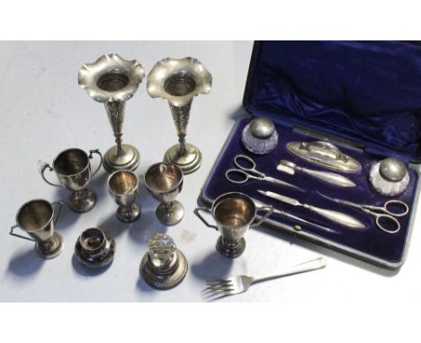 A mixed lot silver items to include a cased vanity set, Levi &amp; Salamon, Birmingham 1910, five trophies and a fork , vario