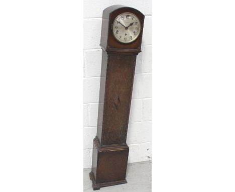An early 20th century oak chiming eight day grandmother clock the dial set with Arabic numerals, raised on bracket feet, leng