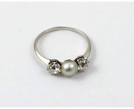 A Victorian white metal, diamond and pearl ladies' dress ring, the central 7mm pearl flanked by two 25 pint diamonds, size P1