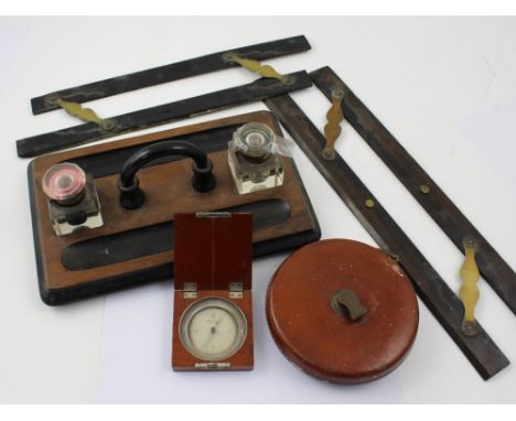 An ebonised walnut twin inkwell partners desk tidy and two sets of ebony parallel rules, Keuffel &amp; Esser Co mahogany case