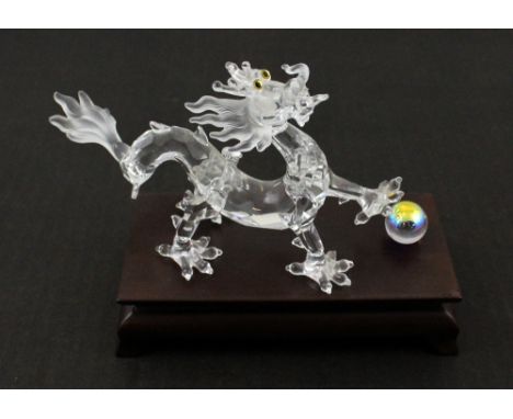 A Swarovski Chinese dragon and Pearl of Wisdom on stand, height 11.5cm overall, with original packaging.