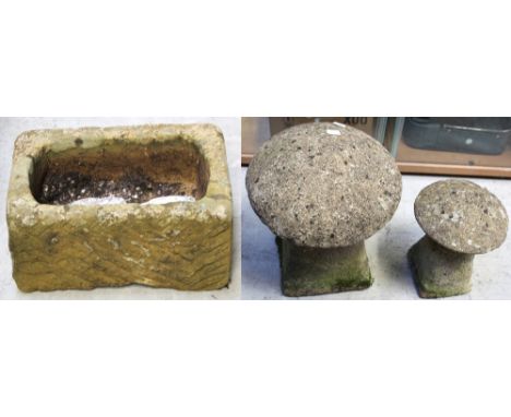 A 19th century small hand-hewn stone trough, 20 x 41 x 27cm, and two small graduated staddle stones (3).