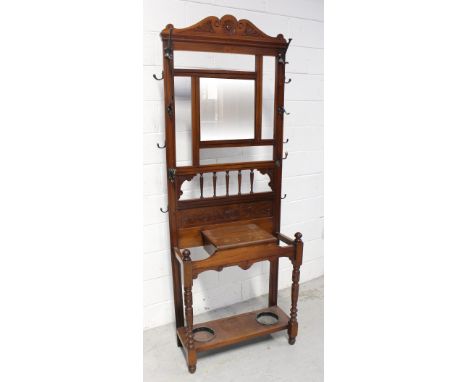 A late Victorian red walnut hall stand with single mirror over bobbin-turned gallery, supported on turned legs, height 203cm.