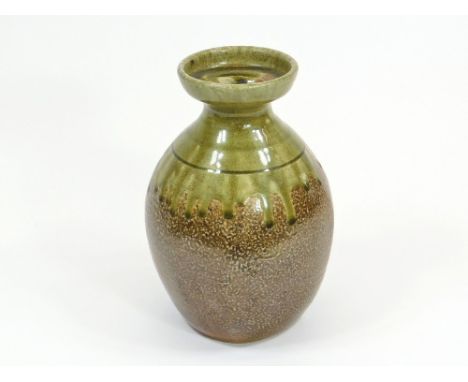 RICHARD BATTERHAM.A bottle vase with a running olive green glaze over salt glaze by Richard Batterham. Height 22cm. 