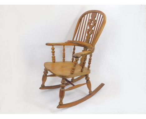 WINDSOR ARMCHAIR. An early 19th century elm Windsor, lath back armchair. (Rockers added at a later date).NOTE: Our postal shi