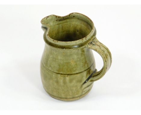 RICHARD BATTERHAM.A ¼ pint jug with olive green glaze by Richard Batterham. Height 11cm.