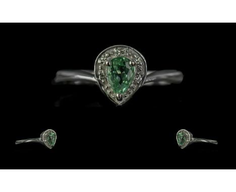 18ct White Gold Ladies Contemporary Dress Ring, pear shaped with central blue stone surrounded by small diamonds. Ring size M