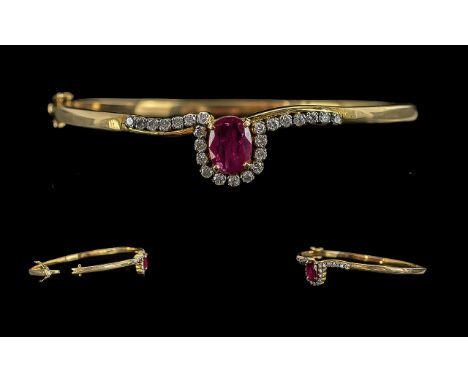 Ladies Pleasing Quality 9ct Gold Diamond and Ruby Set Hinged Bangle, marked 9ct, the centre ruby of good colour, the surround