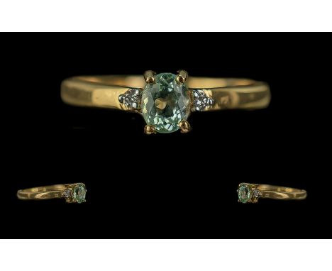 18ct Gold Ladies Dress Ring, central pale green stone with a single diamond on each shoulder.  Ring size N.
