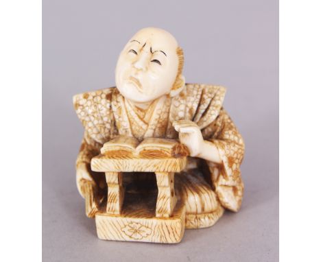 A GOOD QUALITY SIGNED JAPANESE MEIJI PERIOD IVORY NETSUKE OF A SEATED SCHOLAR, with a grimacing face, a book laid open before