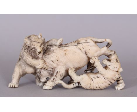 A JAPANESE MEIJI PERIOD IVORY OKIMONO OF A BEAR &amp; A TIGER ATTACKING A BOAR, the details naturalistically rendered and sta