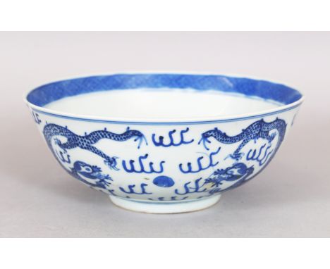 A 19TH CENTURY CHINESE BLUE &amp; WHITE PORCELAIN DRAGON BOWL, the base with a four-character Kangxi mark, 7.1in diameter &am