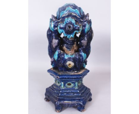 AN UNUSUAL CHINESE MING DYNASTY FAHUA GLAZED CERAMIC MODEL OF A GROTTO, on a separate fitted hexagonal-section stand, the gro