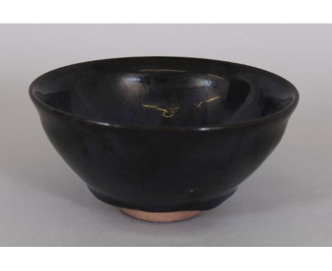 A CHINESE SONG STYLE OIL SPOT CERAMIC TEA BOWL, the lustrous black glaze incorporating areas of purple, 5.1in diameter &amp; 