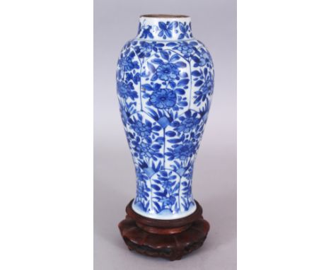 A CHINESE KANGXI PERIOD BLUE &amp; WHITE MOULDED PORCELAIN VASE, together with a wood stand, the sides painted with lappet pa