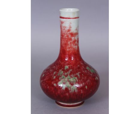 A CHINESE PEACH BLOOM GLAZED PORCELAIN BOTTLE VASE, the base with a six-character Kangxi mark, 7.1in high.