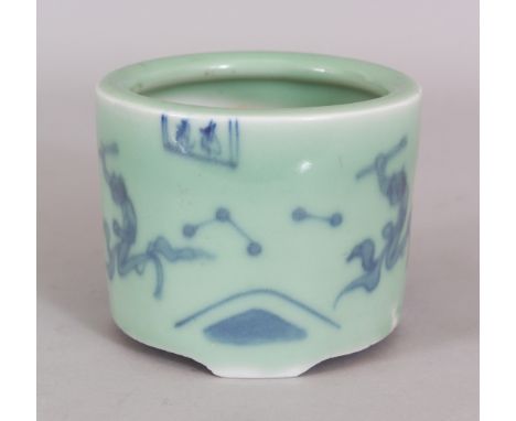 AN ORIENTAL UNDERGLAZE-BLUE &amp; CELADON PORCELAIN TRIPOD CENSER, painted with small panels of calligraphy and repeated figu