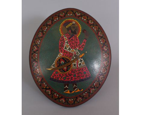 AN EARLY 20TH CENTURY INDIAN ENAMELLED METAL &amp; WOOD MOUNTED OVAL PORTRAIT OF A MAHARAJA, 11.6in x 9.7in at widest points.