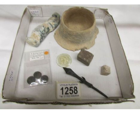 A group of antiquities to include: Roman flat bases terra cotta pot, three Roman coins (id on plastic wallet), a Roman Intagl