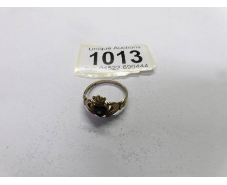 A ladies claddagh ring in 9ct yellow gold with black enamel heart.  Ring size Q half, total weight 1.76 grams.