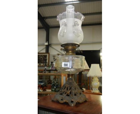 A cast metal base oil lamp with etched shade
