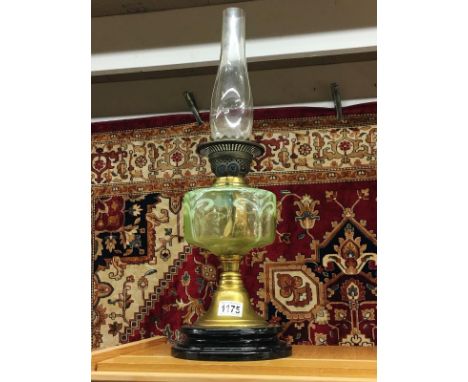 A Victorian oil lamp with vaseline glass font