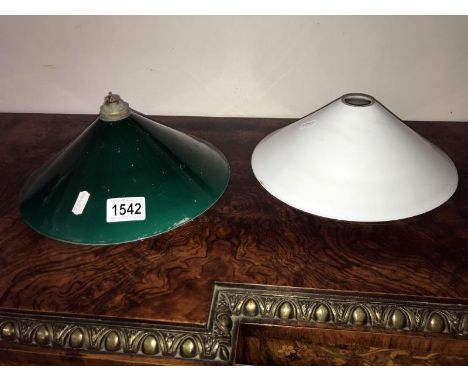 A green glass lamp shade and a white glass lamp shade.