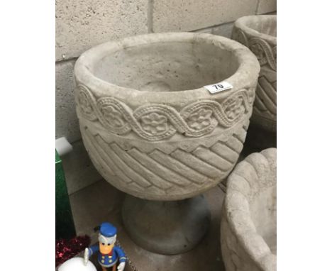 A Mayan circular planter decorated with aztec design