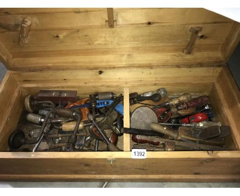 A large wooden tool box (approximately 32" x 14" x 10") with vintage tools.