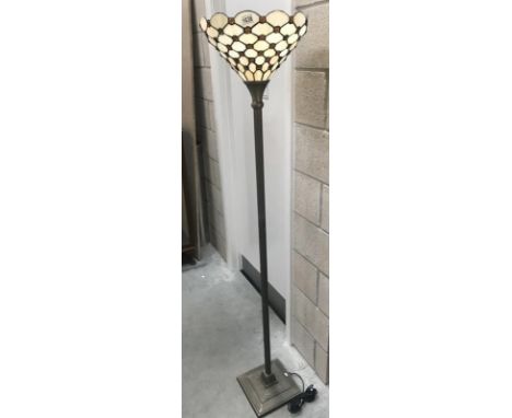 An uplighter standard lamp with Tiffany style shade.