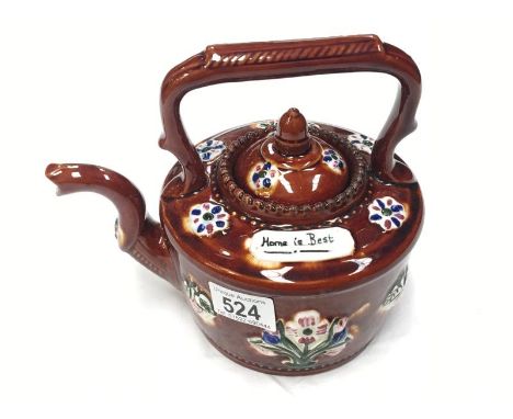 A home is best' brown glazed teapot with floral decorations
