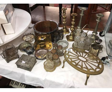 A collection of silver plated items including condiment sets, trinket box &amp; brass candlesticks &amp; trivets etc.