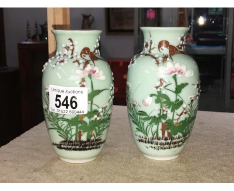 A pair of green decorated ceramic vases - bird &amp; relief - cast flowers