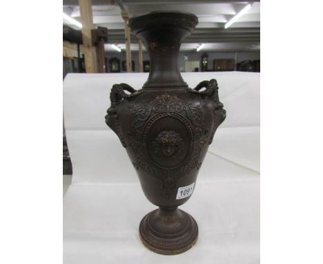 A twin handled ceramic vase with portrait to front and mask handles, marked WSSS 193.