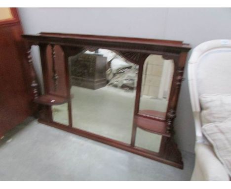A mahogany over mantel mirror.