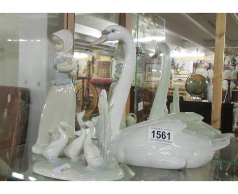 A large Lladro swan, a NAO geese study and a NAO figure of a girl with puppy.